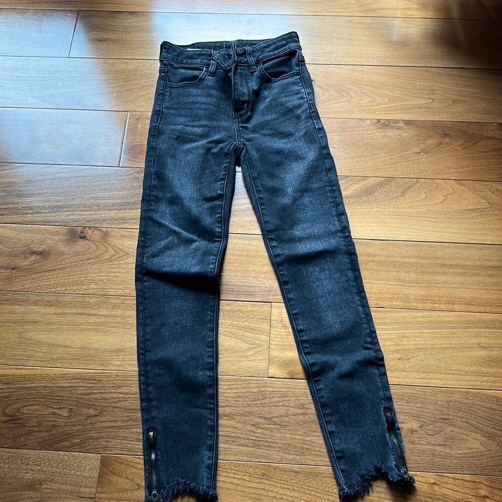 Black jeans with zippers at the end